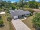 Aerial view of a charming home with a screened pool and a spacious, treed lot at 2550 Meadowview Ln, Deland, FL 32720