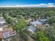 An aerial view of a community with mature trees, homes, a screened-in pool and a shed at 2550 Meadowview Ln, Deland, FL 32720