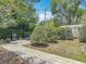 The landscaped backyard features brick paver paths, mature trees, a grill, and a storage shed at 2550 Meadowview Ln, Deland, FL 32720