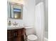 This bathroom features a sink with cabinets, a toilet, a shower with a white shower curtain and white walls at 2550 Meadowview Ln, Deland, FL 32720