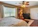Comfortable bedroom features a ceiling fan, window with blinds, and a wooden dresser at 2550 Meadowview Ln, Deland, FL 32720
