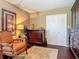 Well-lit bedroom with an accent chair and a full dresser at 2550 Meadowview Ln, Deland, FL 32720