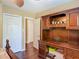 This bedroom features hardwood floors, two closets, and a large wooden desk with drawers and cabinets at 2550 Meadowview Ln, Deland, FL 32720