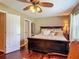Bedroom with hard wood floors, a ceiling fan, and view into the home at 2550 Meadowview Ln, Deland, FL 32720
