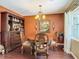 The dining room features an elegant chandelier, hardwood floors and detailed wainscotting at 2550 Meadowview Ln, Deland, FL 32720