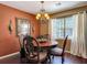 The dining room offers a beautiful chandelier, hardwood floors and natural lighting at 2550 Meadowview Ln, Deland, FL 32720