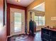 Inviting entryway featuring a decorative glass door, rich wood floors, and stylish accents at 2550 Meadowview Ln, Deland, FL 32720