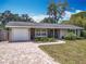 Charming single-story home featuring stone accents, a front-entry garage, and lush landscaping at 2550 Meadowview Ln, Deland, FL 32720
