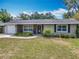 Charming single-story home featuring stone accents, a front-entry garage, and lush landscaping at 2550 Meadowview Ln, Deland, FL 32720