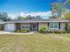 Charming single-story home featuring stone accents, a front-entry garage, and lush landscaping at 2550 Meadowview Ln, Deland, FL 32720