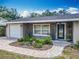 Charming single-story home featuring stone accents, a front-entry garage, and lush landscaping at 2550 Meadowview Ln, Deland, FL 32720