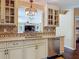 A view of the kitchen sink and granite counters with a beautiful chandelier above at 2550 Meadowview Ln, Deland, FL 32720