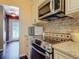 Kitchen featuring stainless steel appliances, stone countertops, and plenty of cabinet space at 2550 Meadowview Ln, Deland, FL 32720