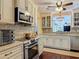 This open kitchen features granite counters, tile backsplash, and stainless steel appliances at 2550 Meadowview Ln, Deland, FL 32720