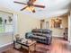 Open living area with hardwood floors, comfortable seating and stylish decor at 2550 Meadowview Ln, Deland, FL 32720