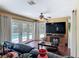Living room with a view of the outdoor pool through French doors and a mounted television at 2550 Meadowview Ln, Deland, FL 32720