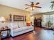 The inviting living room features hardwood floors, a comfortable sofa and a decorative aesthetic at 2550 Meadowview Ln, Deland, FL 32720