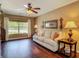 Relaxing living room bathed in natural light and complete with comfortable seating and hardwood floors at 2550 Meadowview Ln, Deland, FL 32720