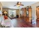 This living room offers a decorative hutch, hardwood floors, and bright natural lighting at 2550 Meadowview Ln, Deland, FL 32720