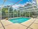 This is a beautiful screened in pool, surrounded by green foliage in the back yard at 2550 Meadowview Ln, Deland, FL 32720