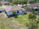 Aerial view of a property showcasing the backyard, patio, landscaping, and the home's exterior at 2620 Abbey Ave, Orlando, FL 32833
