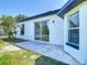 Home exterior with white siding, black trim, and a concrete patio at 2620 Abbey Ave, Orlando, FL 32833