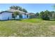 The backyard has a large grassy area and a concrete patio at 2620 Abbey Ave, Orlando, FL 32833