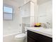Bright bathroom featuring a tub with shower, white vanity, and storage cabinet at 2620 Abbey Ave, Orlando, FL 32833