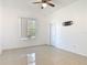 Spacious bedroom with tiled floor, a ceiling fan, and natural light from the window at 2620 Abbey Ave, Orlando, FL 32833