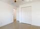 A sunny bedroom with tile floors and a bi-fold closet at 2620 Abbey Ave, Orlando, FL 32833