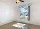 A cozy bedroom with large window and a ceiling fan at 2620 Abbey Ave, Orlando, FL 32833