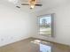 A bright bedroom features tile floors, fan, and a large window view at 2620 Abbey Ave, Orlando, FL 32833
