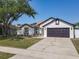 Charming single-story home showcasing a well-maintained lawn and a two-car garage at 2620 Abbey Ave, Orlando, FL 32833