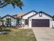 Charming single-story home showcasing a well-maintained lawn and a two-car garage at 2620 Abbey Ave, Orlando, FL 32833