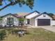 Charming single-story home showcasing a well-maintained lawn and a two-car garage at 2620 Abbey Ave, Orlando, FL 32833