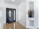 Elegant foyer with a decorative niche, tiled flooring, and stylish front door at 2620 Abbey Ave, Orlando, FL 32833