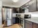 A well-equipped kitchen features stainless steel appliances and sleek dark cabinetry at 2620 Abbey Ave, Orlando, FL 32833