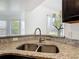 Close up on the kitchen sink and granite counters with backyard views at 2620 Abbey Ave, Orlando, FL 32833