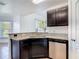 Kitchen area featuring stainless steel dishwasher, sink, and granite countertops at 2620 Abbey Ave, Orlando, FL 32833