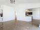 Open-concept living space features tile floors, a view into the kitchen, and neutral wall colors at 2620 Abbey Ave, Orlando, FL 32833