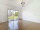 Bright living room featuring tile flooring, high ceilings, and sliding glass doors to backyard at 2620 Abbey Ave, Orlando, FL 32833