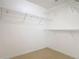 Spacious walk-in closet featuring installed shelving and tiled floor at 2620 Abbey Ave, Orlando, FL 32833