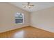 Bright bedroom with hardwood floors and a large window at 2714 Moncayo Ave, The Villages, FL 32162