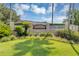 Landscaped entrance to Village Alhambra with colorful flowers and lush green lawn at 2714 Moncayo Ave, The Villages, FL 32162