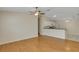 Bright living room with wood floors, a ceiling fan, and an open concept to the kitchen at 2714 Moncayo Ave, The Villages, FL 32162