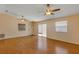 Bright living room featuring laminate wood floors, ceiling fans, and a sliding glass door at 2714 Moncayo Ave, The Villages, FL 32162