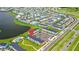 Stunning aerial view showcases colorful vacation homes and lush landscaping near a tranquil lake at 2920 On The Rocks Pt, Kissimmee, FL 34747