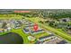 Picturesque aerial view features colorful homes, lush landscapes, and serene lakefront views at 2920 On The Rocks Pt, Kissimmee, FL 34747