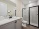 Bathroom with white vanity and walk-in shower at 2920 On The Rocks Pt, Kissimmee, FL 34747