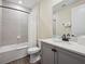 Modern bathroom featuring a gray vanity, white countertop, and tiled shower with glass door at 2920 On The Rocks Pt, Kissimmee, FL 34747